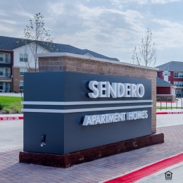 Your future is spelled out for you — take this opportunity to unlock the lifestyle you've been waiting for by visiting our website. a sign in a parking lot