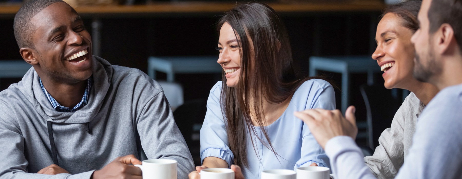 Friends enjoying coffee and laughing