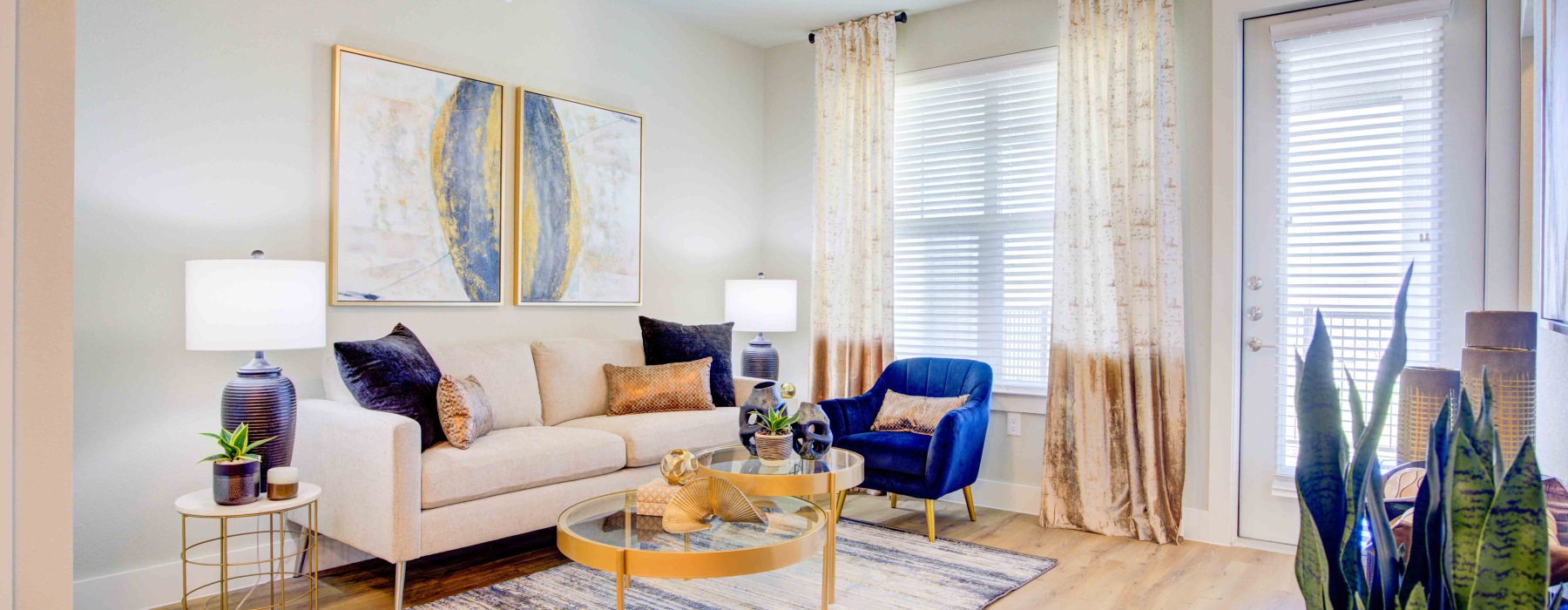 white couch with blue accent chair and pillows. 