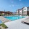 cushioned lounge chairs around pool